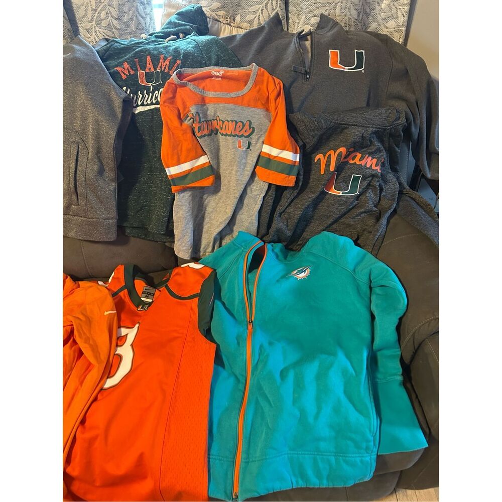Mixed a lot of Miami Dolphins and Miami hurricanes clothing, two men’s sweatshir